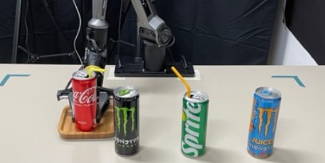 The robot placing the red can on the tray